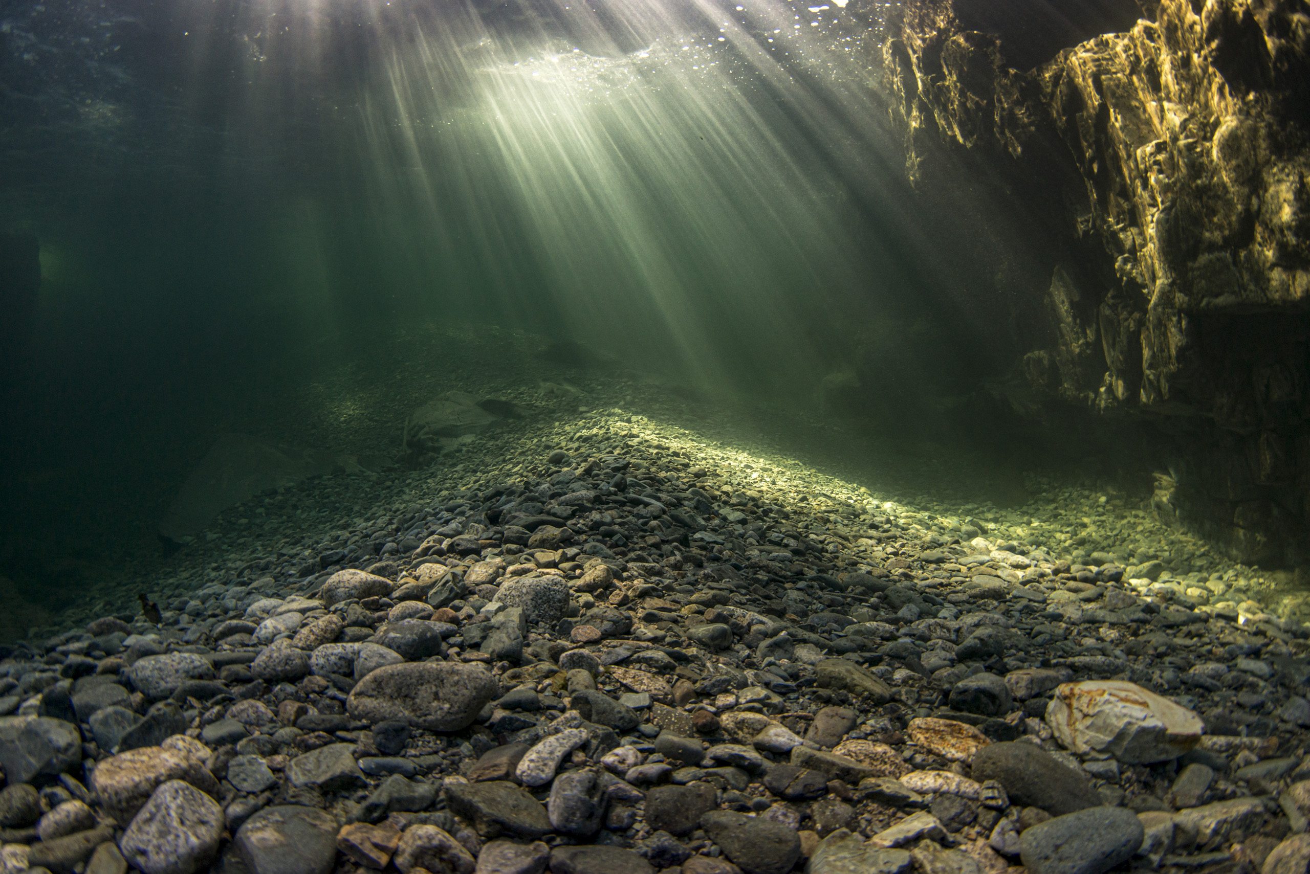 Pile of large gravel and rocks in the pools below Myra Falls.